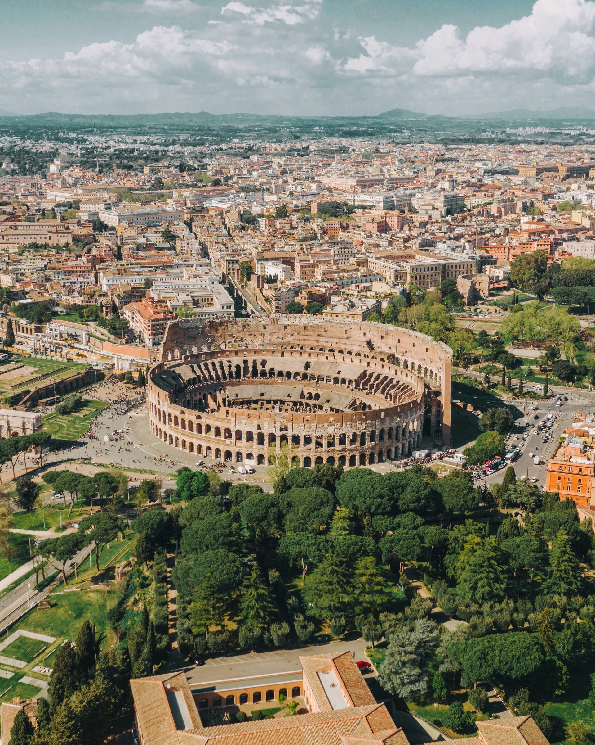 The Colosseum's ancient arena walls under a warm evening sky in Rome