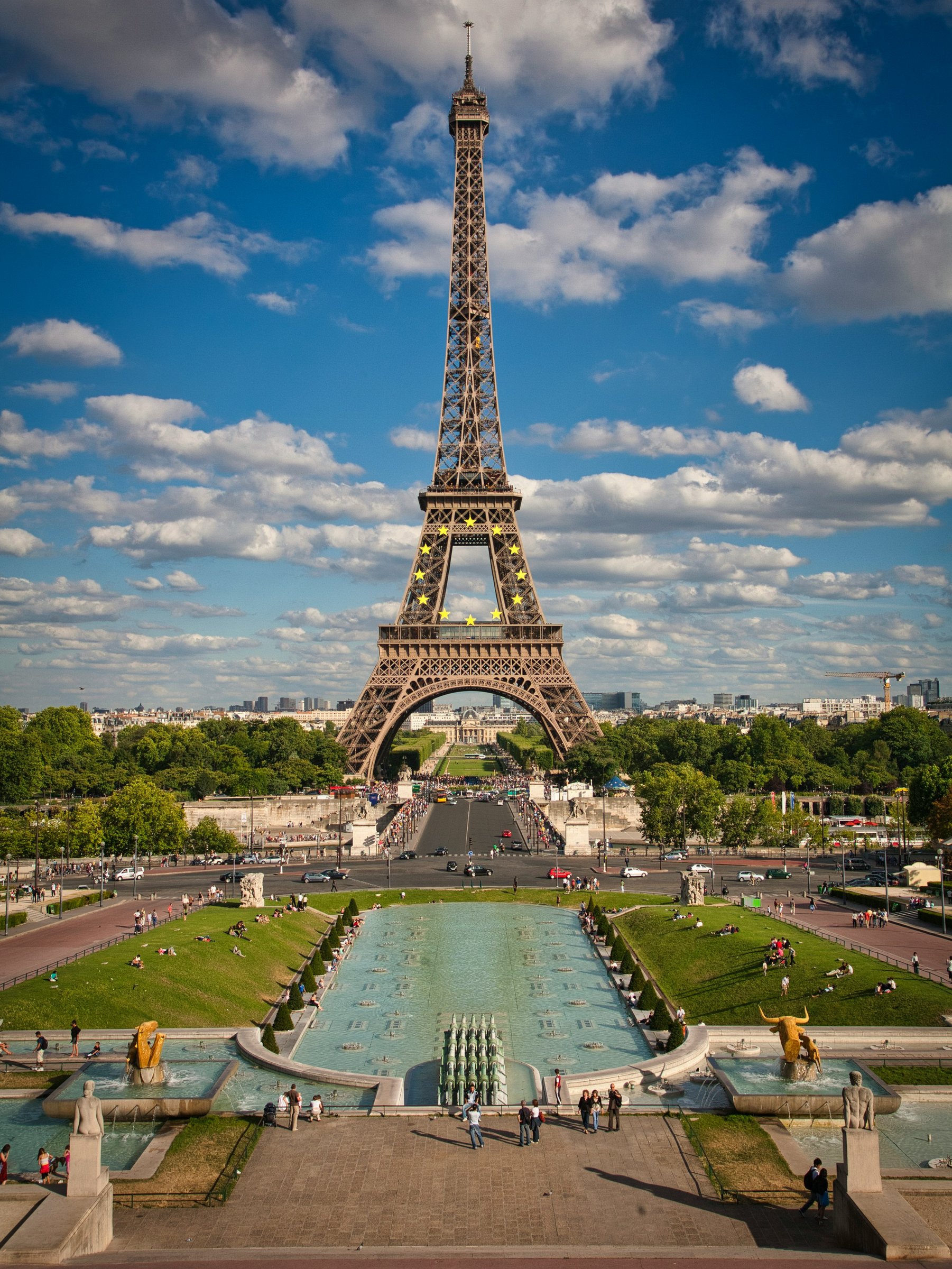 The Eiffel Tower rising above the Trocadéro fountains and gardens under a blue sky in Paris