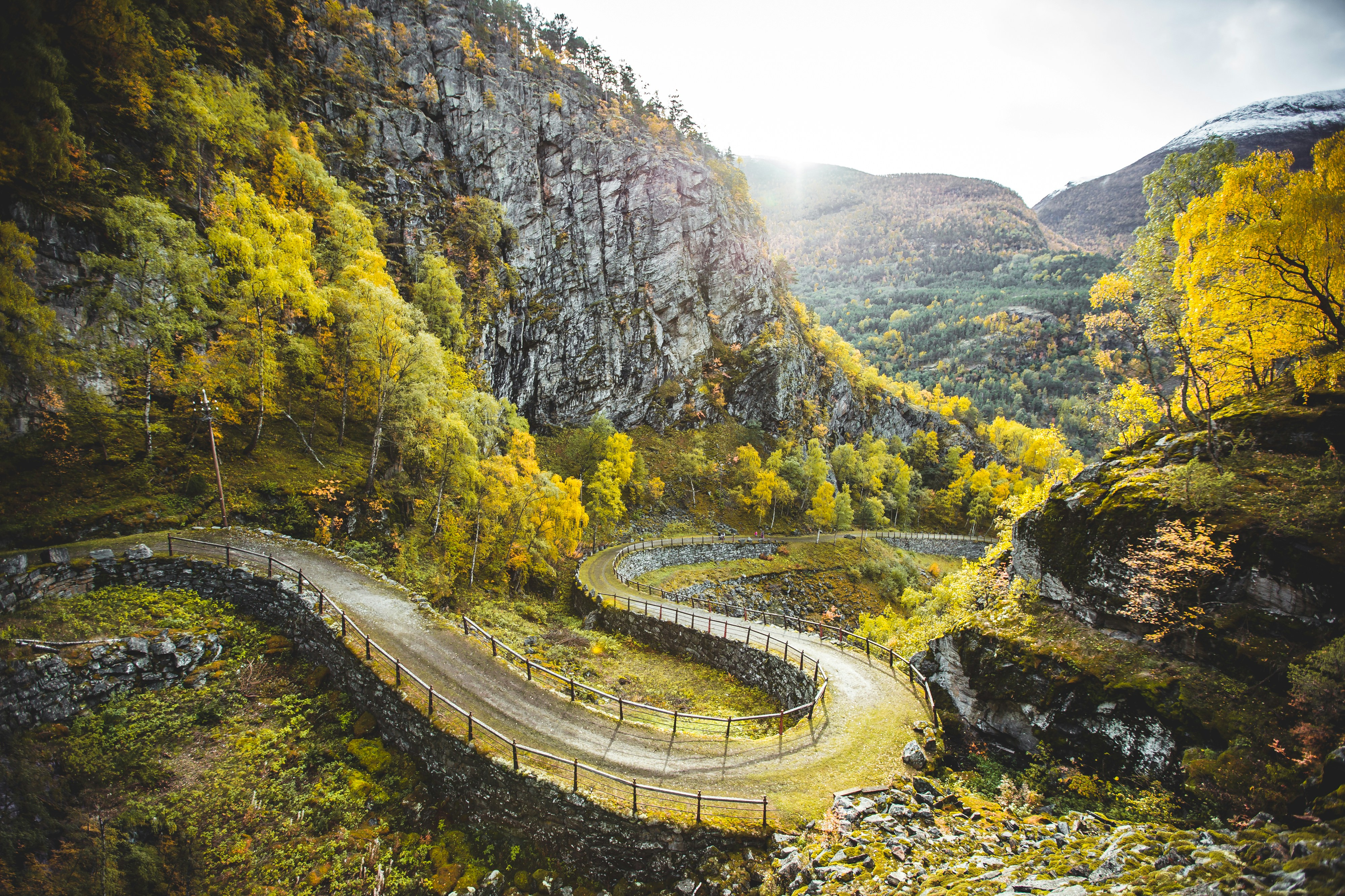 Winding stone-walled mountain path through an autumn gorge near Kyoto