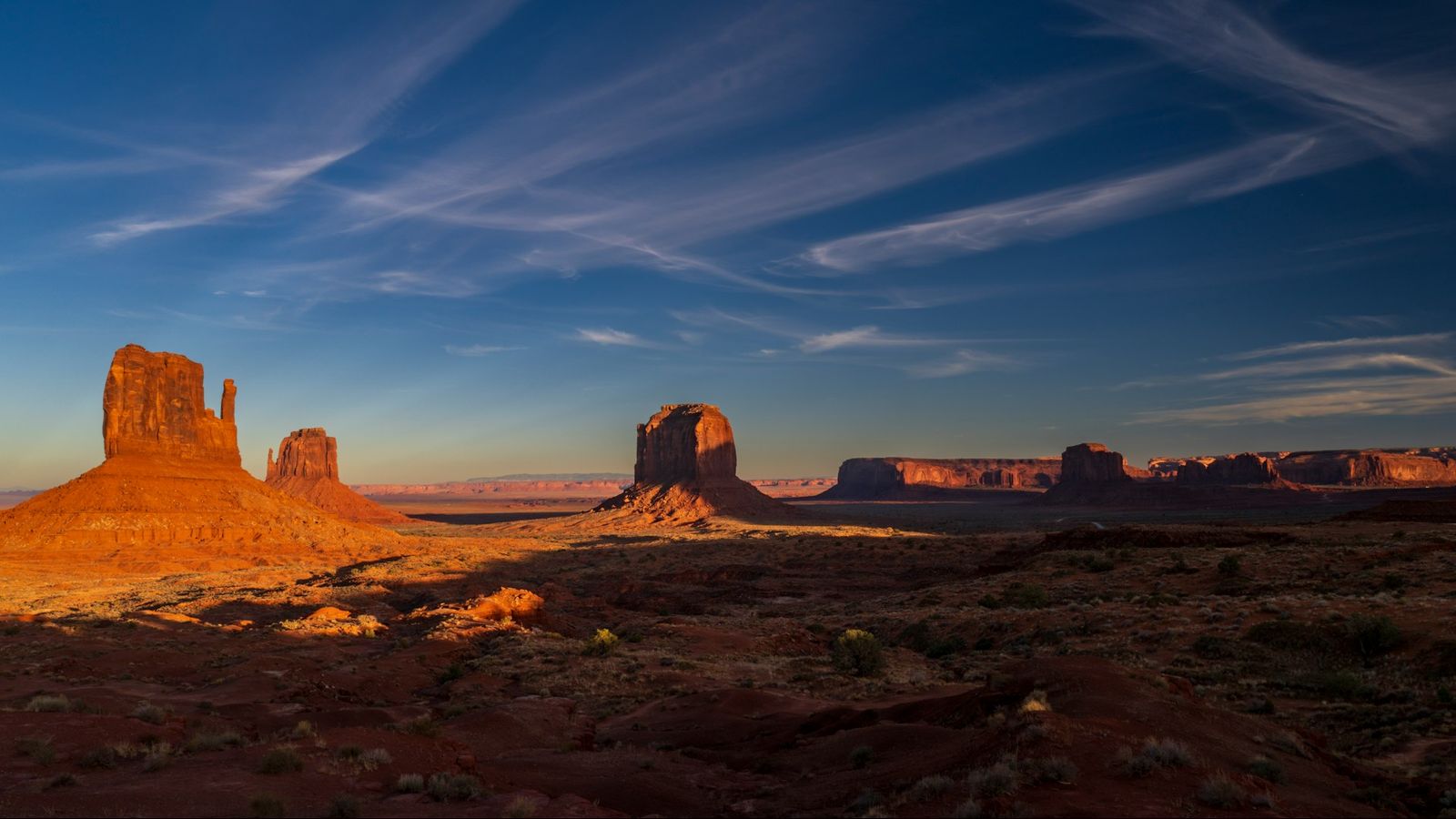 Red sandstone buttes of Monument Valley on the Arizona–Utah border, lit by the evening sun